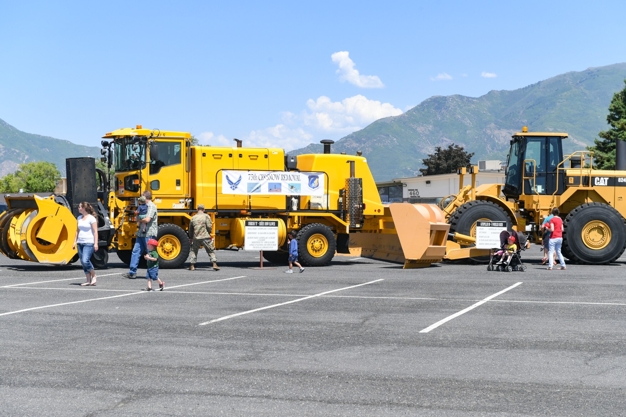 Visitors view snow removal vehicles from the 75th Civil Engineering Squadron during Wheels of Wonder June 8, 2018, at Hill Air Force Base, Utah. Wheels of Wonder provides base families a fun, hands-on experience exploring various types of vehicles. (U.S. Air Force photo by Cynthia Griggs)