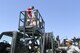 Haidyn and Nixon Sullivan with father Kasey receive a lift on a hydrant refueling truck from Tech. Sgt. T.W. Diamond and Airman 1st Class Wyatt Crothers, both with 75th Logistics Readiness Squadron, June 8, 2018, at Hill Air Force Base, Utah. Wheels of Wonder provides base families a fun, hands-on experience exploring various types of vehicles. (U.S. Air Force photo by Cynthia Griggs)