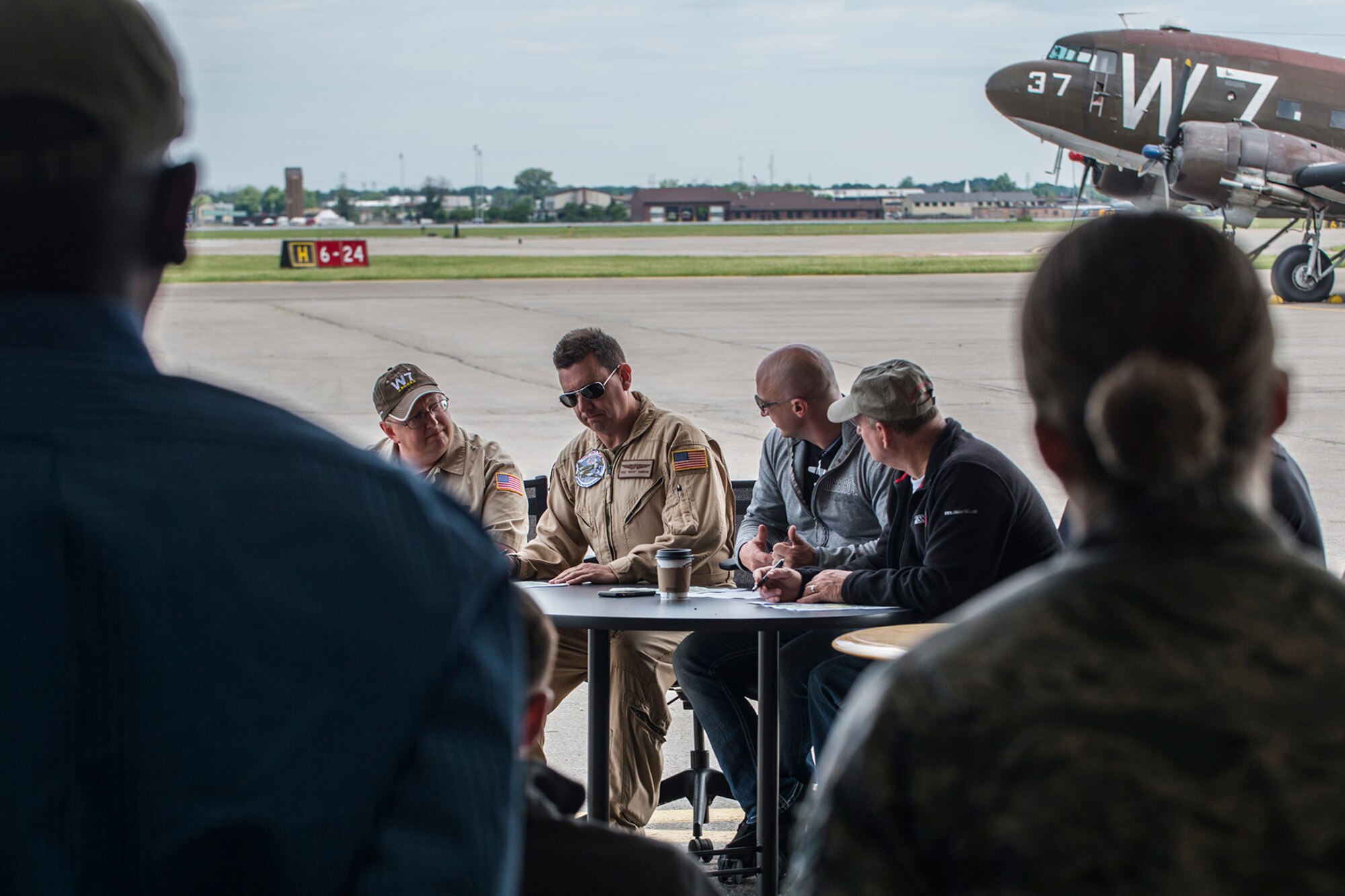 Pilots participating in a Heritage Flight hold a pre-flight briefing prior to takeoff on June 7, 2018, Niagara Falls International Airport, N.Y. The Air Force Heritage Flight Foundation provides dramatic flying displays to the entire world, pairing modern aircraft performances with fighter aircraft from the WWII, Korea and Vietnam eras. (U.S. Air Force photo by Master Sgt. Greg Steele/Released)