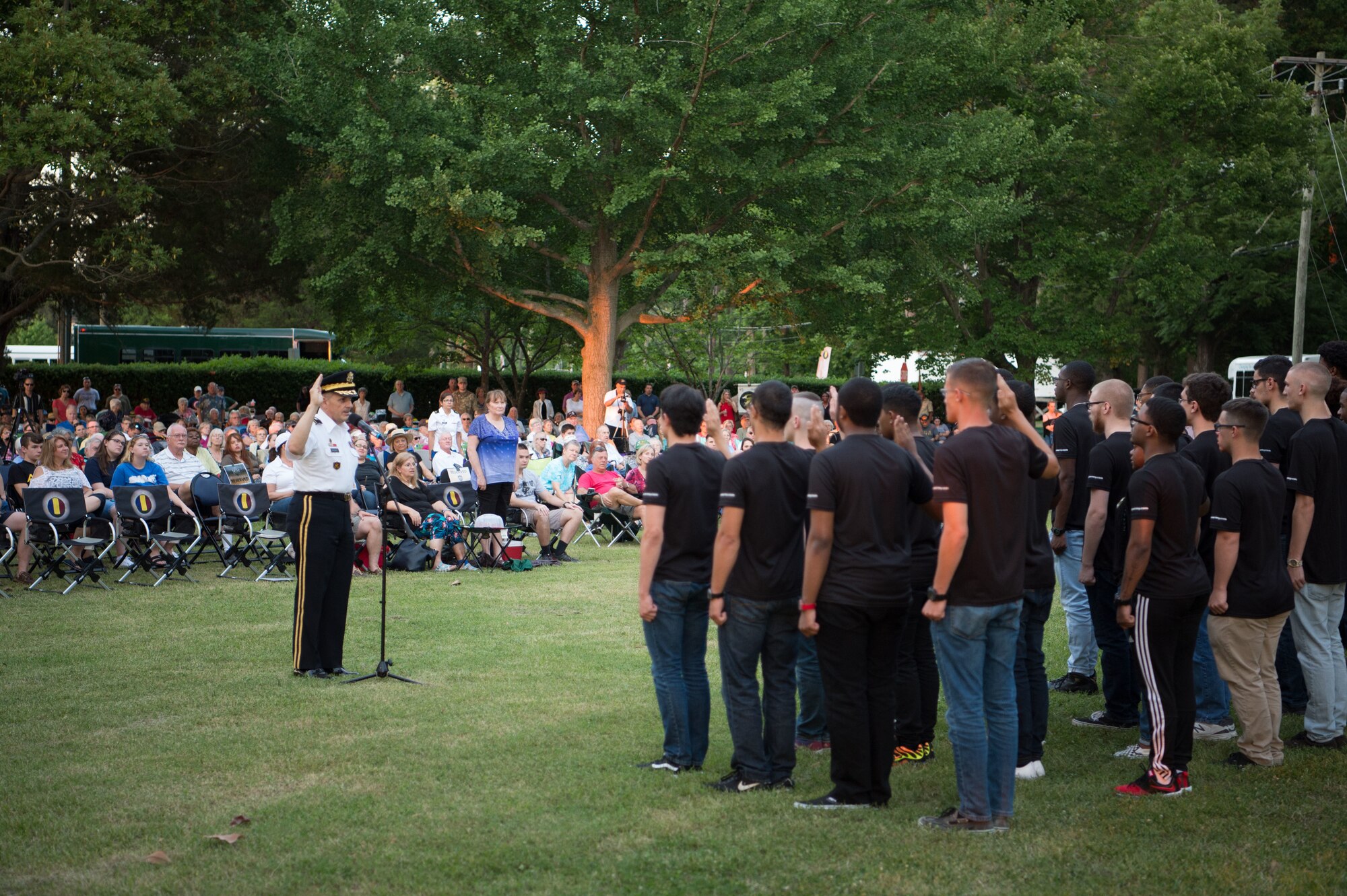 U.S. Army Maj. Gen. Paul M. Benenati, U.S. Army Training and Doctrine Command deputy chief of staff, administers the Oath of Enlistment to Army recruits during the TRADOC Band’s Music Under the Stars concert in honor of the Army’s 243rd Birthday at Joint Base Langley-Eustis, Va., June 15, 2018.