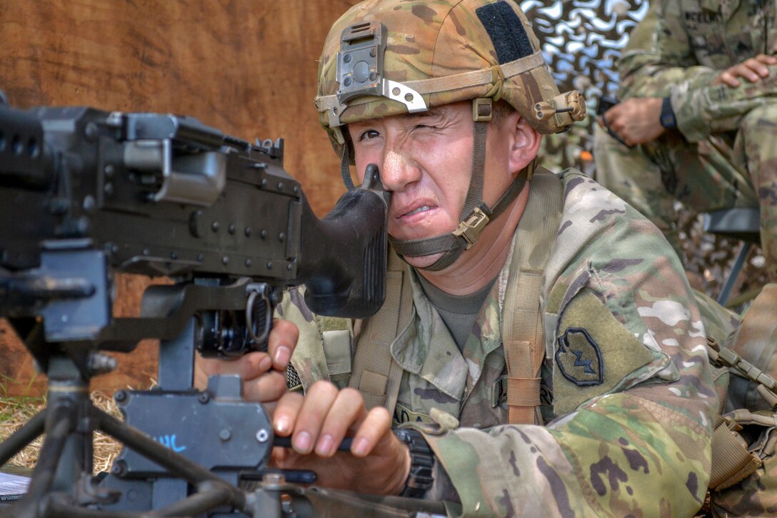 Army Sgt. Matthew Inada prepares the range card for a M240B machine gun.