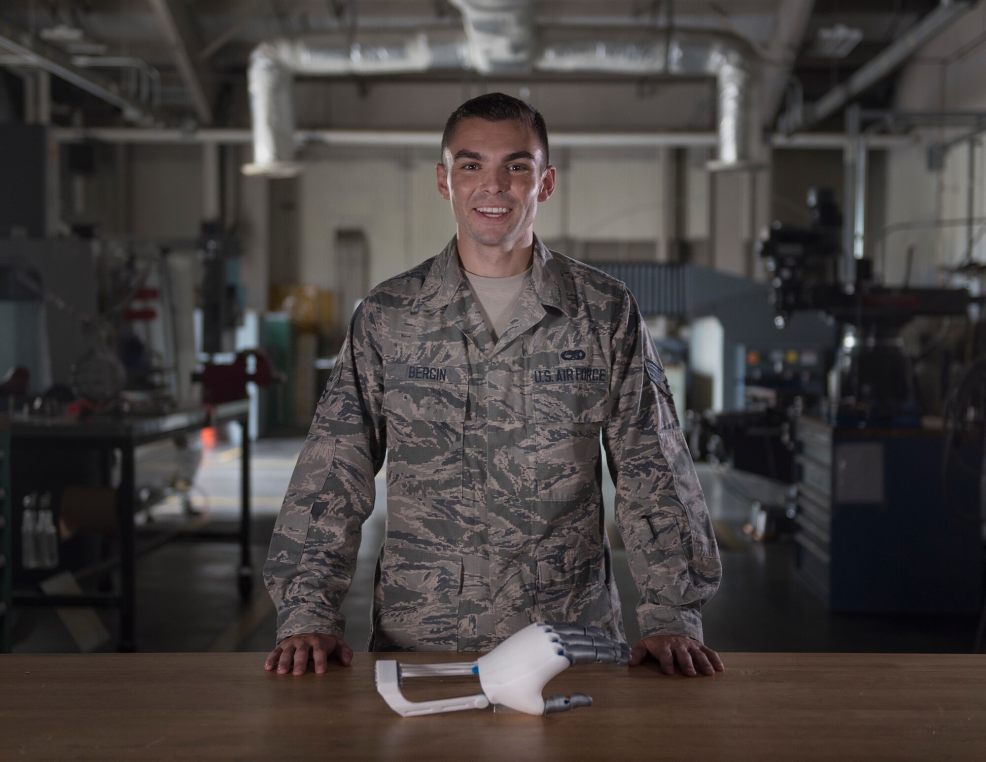 U.S. Air Force Senior Airman Timothy Bergin, 33rd Maintenance Squadron aircraft metals technology journeyman, stands with his prosthetic prototype June 13, 2018, at Eglin Air Force Base, Fla. Bergin used the knowledge he gained from a computer numerical control and heating course, and from within his career field to customize and improve a prosthetic while off duty. (U.S. Air Force photo by Staff Sgt. Peter Thompson)
