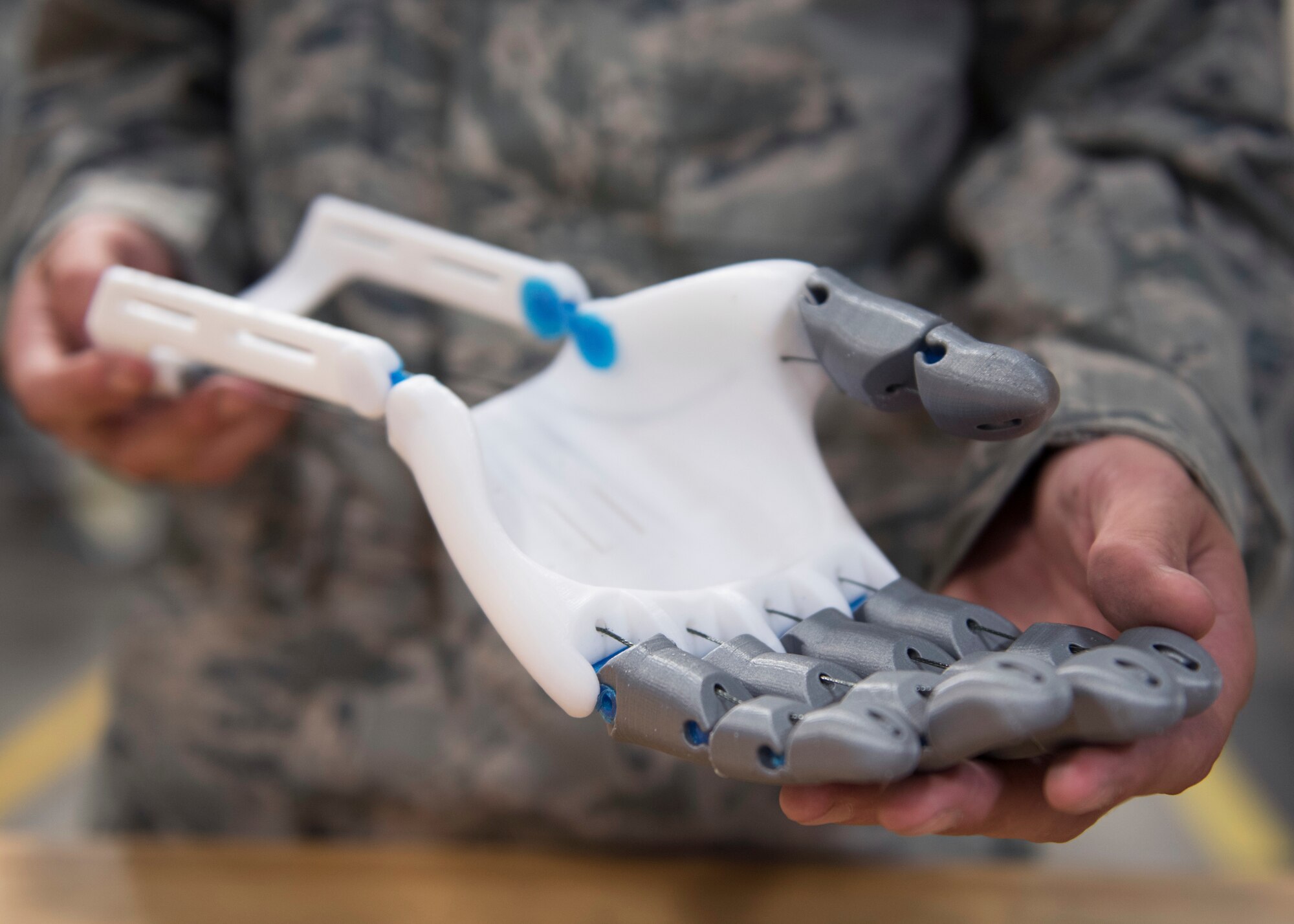 U.S. Air Force Senior Airman Timothy Bergin, 33rd Maintnenance Squadron aircraft metals technology journeyman, holds his prototype prosthetic June 13, 2018, at Eglin Air Force Base, Fla. Bergin found a model of a prosthetic online and began customizing it to improve functionality, lifespan and appearance. In addition to improvements, he says he can reproduce the hand for less than $20. (U.S. Air Force photo by Staff Sgt. Peter Thompson)