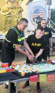 In classic Army tradition, the youngest and oldest soldiers participating in the Army birthday run cut the cake June 14 at Joint Base San Antonio-Fort Sam Houston. Lt. Gen. Jeffrey Buchanan, commanding general, U.S. Army North (Fifth Army), led soldiers and Army civilians on a run in celebration of the U.S. Army’s 243rd Birthday.