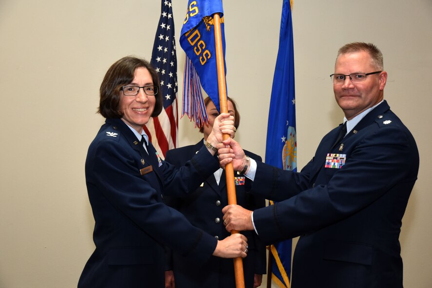 U.S. Air Force Col. Janet Urbanski, 17th Medical Group commander, passes the 17th Medical Support Squadron guideon to Lt. Col. Warren Conrow, 17th MDSS incoming commander, at the 17th MDSS Change of Command at the Event Center on Goodfellow Air Force Base, Texas, June 15, 2018. The change of command ceremony is a time honored military tradition that signifies the orderly transfer of authority. (U.S. Air Force photo by Airman 1st Class Seraiah Hines/Released)