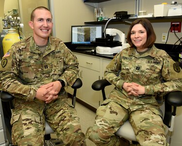 Capt. Andrew W. Holt (left), Ph.D., a former Army field artillery officer, is the new Deputy Director for the Department of Sensory Trauma at the U.S. Army Institute of Surgical Research at Joint Base San Antonio-Fort Sam Houston. Holt, a physiologist, is taking over for Capt. Gina Griffith (right), Ph.D., who just completed her first tour in the Army as a microbiologist at the USAISR and transferring to a deployable unit at Aberdeen Proving Ground, Maryland.