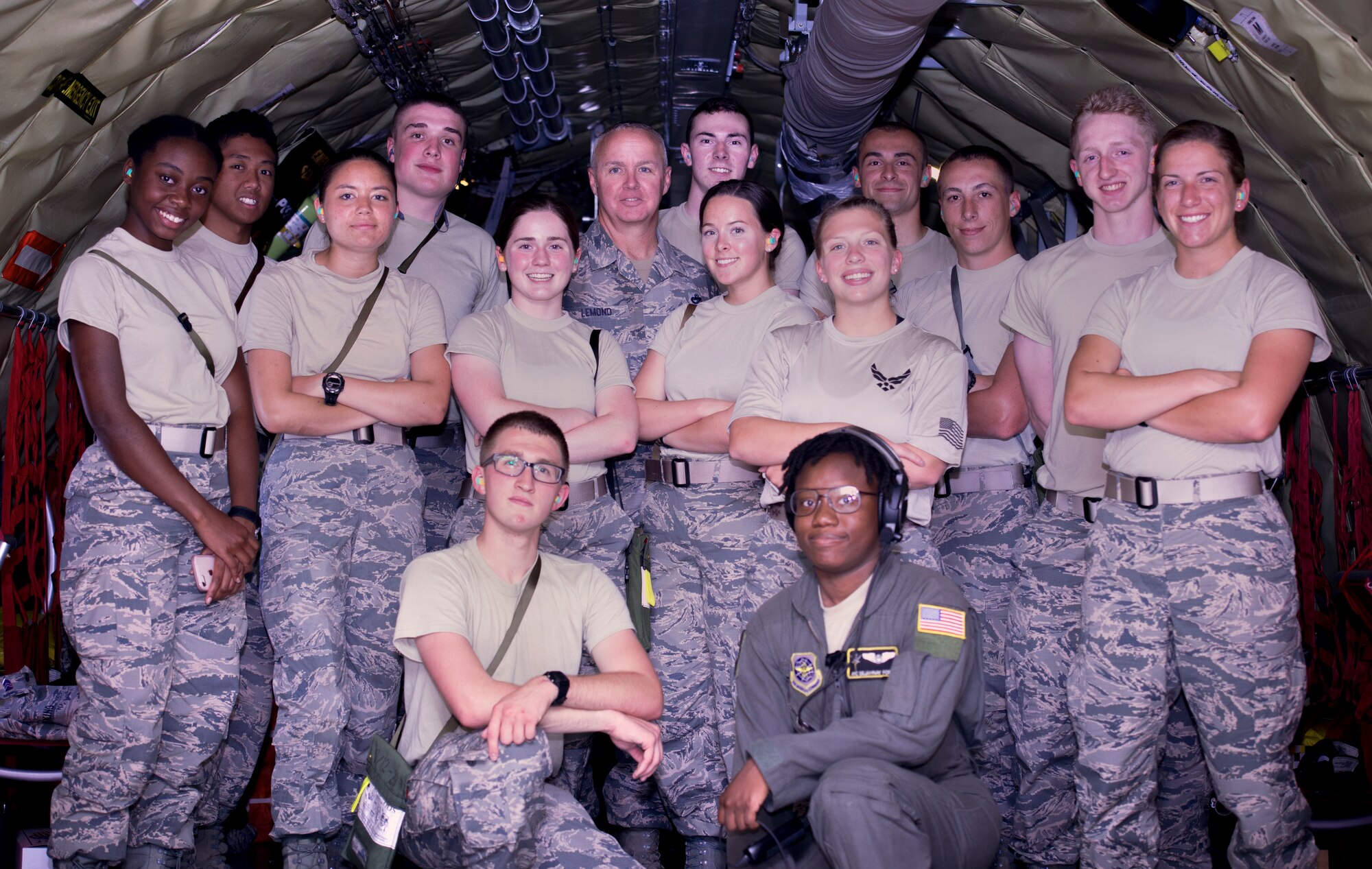 U.S. Air Force Reserve Officer Training Corps (ROTC) cadets pause for a photo with Chief Master Sgt. Michael Lemond, the superintendent assigned to the 6th Mission Support Group and Airman 1st Class Dejahnay Fort, a boom operator assigned to the 91st Air Refueling Squadron, during a KC-135 Stratotanker aircraft incentive flight June 14, 2018.