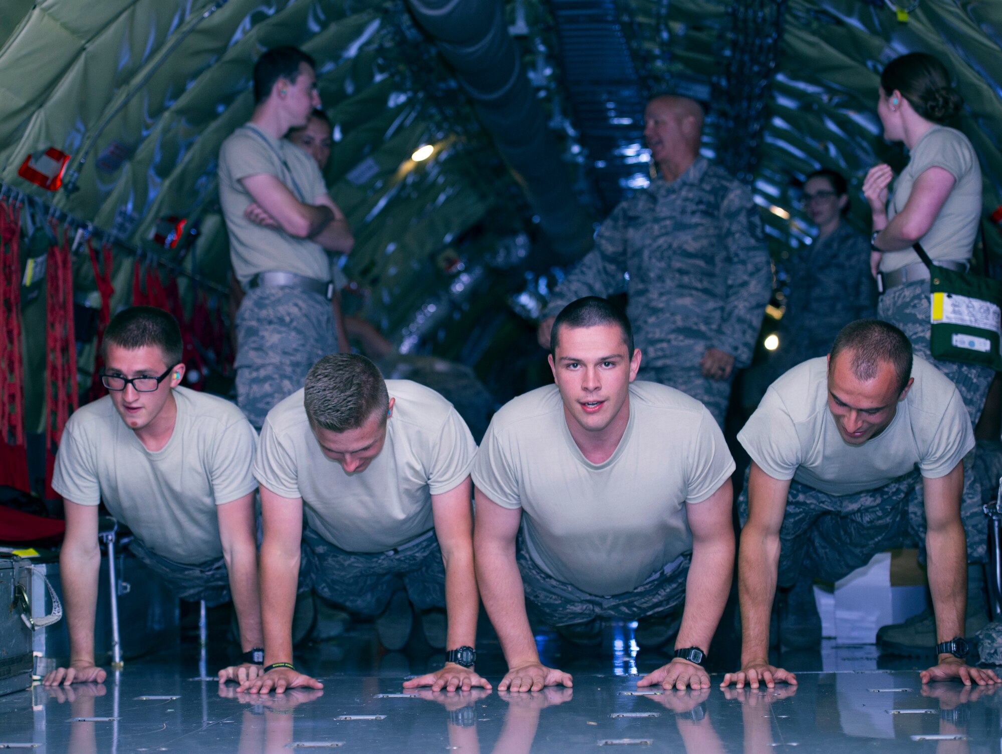 U.S. Air Force Reserve Officer Training Corps (ROTC) cadets perform pushups while calling cadence during a KC-135 Stratotanker aircraft incentive flight June 14, 2018 over the Eastern United States.