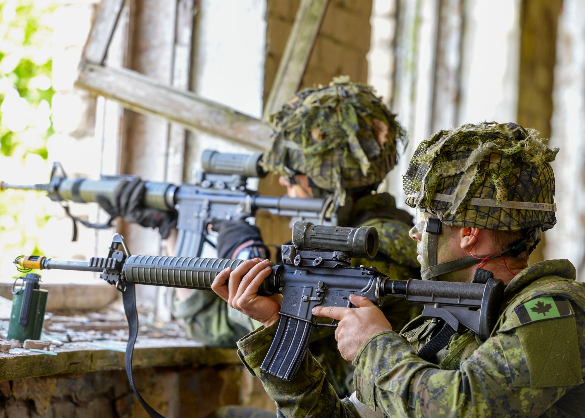 Members of a Canadian Platoon fire at opposing forces during an exercise in Skrunda, Latvia on June 13, 2018. Canadian forces were teamed with Spanish, Italian, and Latvian platoons to act as a defending force during a battle simulation for Saber Strike 18. Saber Strike included approximately 18,000 participants from 19 countries to continue building on interoperability. (U.S. Air Force photo by Staff Sgt. Jimmie D. Pike)
