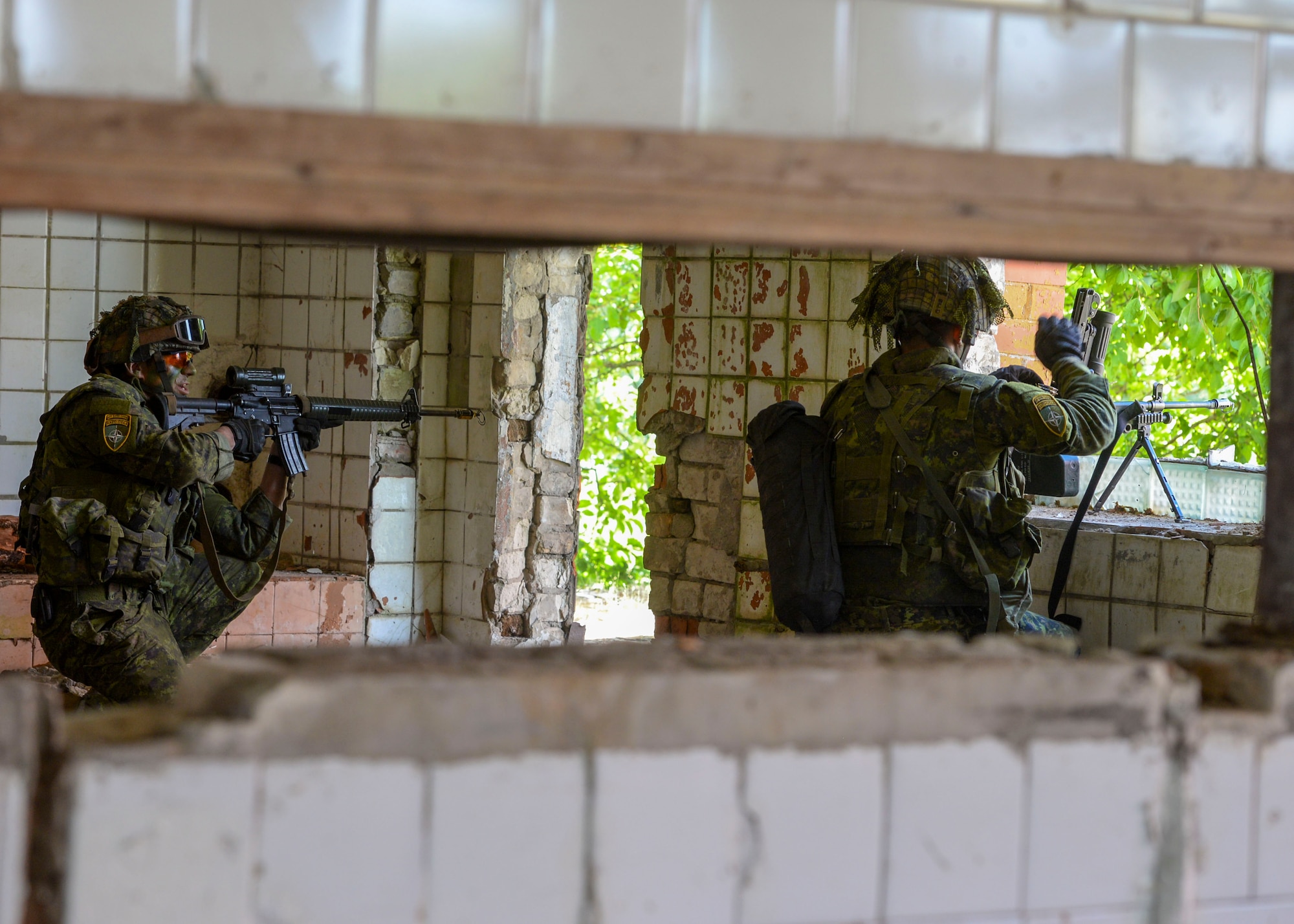 Members of a simulated defense force defend their post during an exercise in Skrunda, Latvia on June 13, 2018. The exercise was a part of Saber Strike 18 and featured a defending force comprised of Spanish, Italian, Canadian and Latvian Platoons; and an attacking force comprised of U.S. Marines, United Kingdom Royal Marines, Michigan Army National Guard, and Norwegian Forces. Saber Strike 18 is the eighth iteration of the long-standing U.S. Army Europe-led cooperative training exercise enhancing interoperability among allies and regional partners.  (U.S. Air Force photo by Staff Sgt. Jimmie D. Pike)