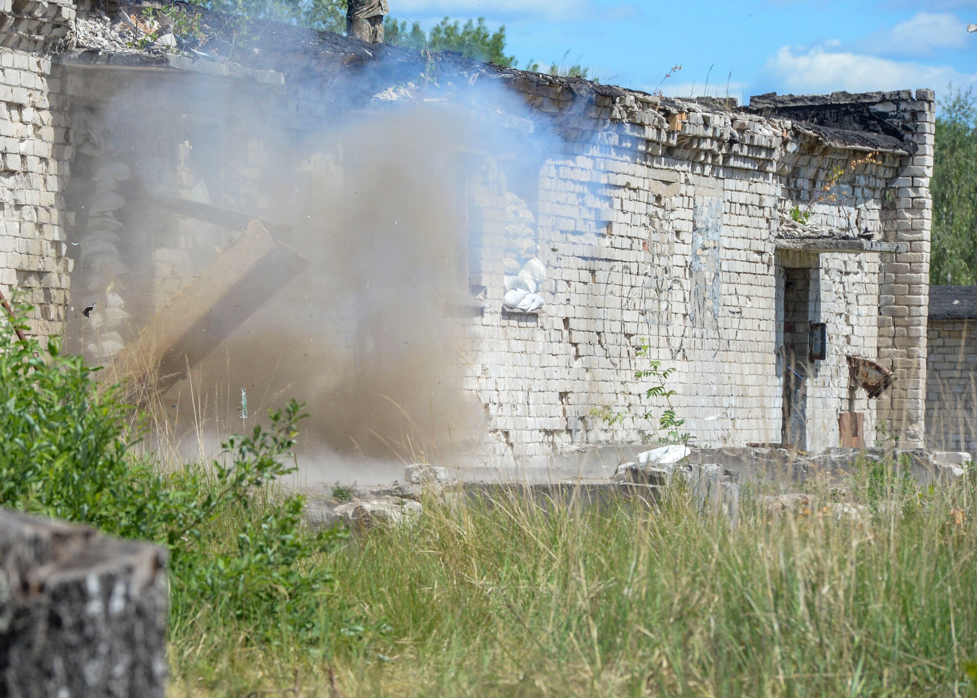 A door blows open by the force of a detonated charge during an exercise in Skrunda, Latvia on June 13, 2018. Attacking Forces comprised of U.S. Marines, United Kingdom Royal Marines, Michigan Army National Guard, and Norwegian Forces during a battle simulation for Saber Strike. Saber Strike 18 is the eighth iteration of the long-standing U.S. Army Europe-led cooperative training exercise enhancing interoperability among allies and regional partners. (U.S. Air Force photo by Staff Sgt. Jimmie D. Pike)