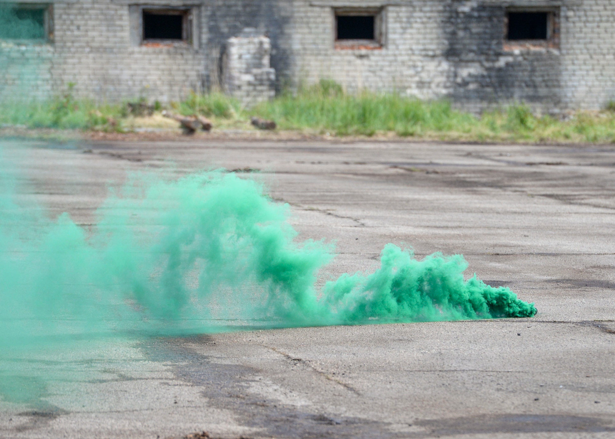 Green smoke marks the landing zone for a Latvian MI-17 Helicopter to land for a simulated medical evacuation during an exercise in Skrunda, Latvia on June 13, 2018. The battle was part of Saber Strike 18 and pieced together communication, tactics, and other facets of military operation into one scenario. (U.S. Air Force photo by Staff Sgt. Jimmie D. Pike)