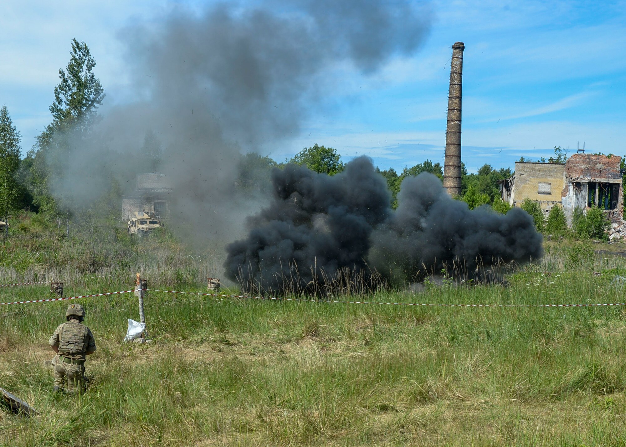 Explosive charges detonate on a simulated battlefield during a large scale battle scenario in Skrunda, Latvia on June 13, 2018. The scenario was a part of Saber Strike 18 and featured a defending force comprised of Spanish, Italian, Canadian and Latvian Platoons; and an attacking force comprised of U.S. Marines, United Kingdom Royal Marines, Michigan Army National Guard, and Norwegian Forces. (U.S. Air Force photo by Staff Sgt. Jimmie D. Pike)