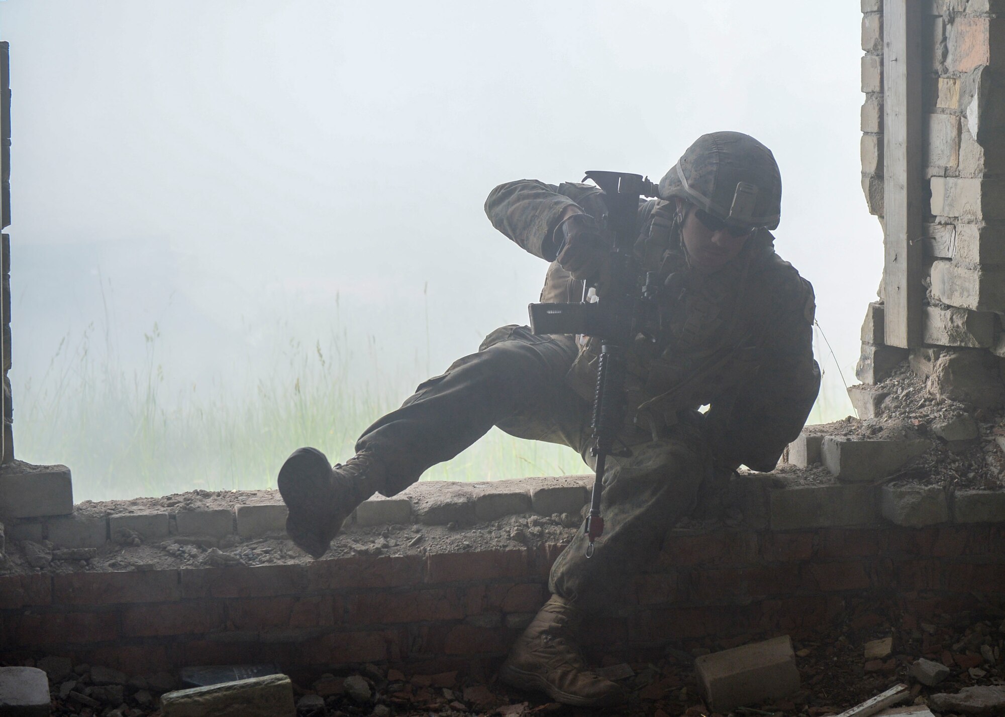 A U.S. Marine breaches a building during a large scale battle scenario during Saber Strike 18 in Skrunda, Latvia on June 13, 2018. U.S Marines teamed with United Kingdom Royal Marines, Michigan Army National Guard, and Norwegian Forces as the attacking force whose objective was to remove opposing forces. Saber Strike aims to improve strategic partnerships, ability to operate in the dynamic security environment, and to maintain readiness of forces. (U.S. Air Force photo by Staff Sgt. Jimmie D. Pike)
