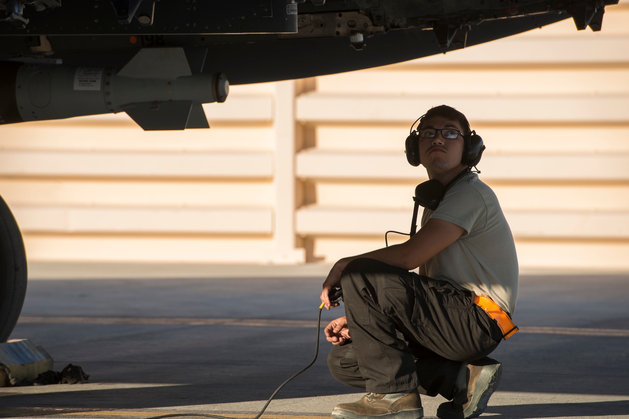 An image of Airman 1st Class Connor Badton, 3911st Fighter Squadron assistant dedicated crew chief, inspects an F-15E Strike Eagle during Green Flag West, June 13, 2018, at Nellis Air Force Base, Nevada. The 391st FS participated in Green Flag to further enhance readiness by training on Close Air Support over the National Training Center, Fort Irwin, California. (U.S. Air Force Photo by Airman 1st Class JaNae Capuno)