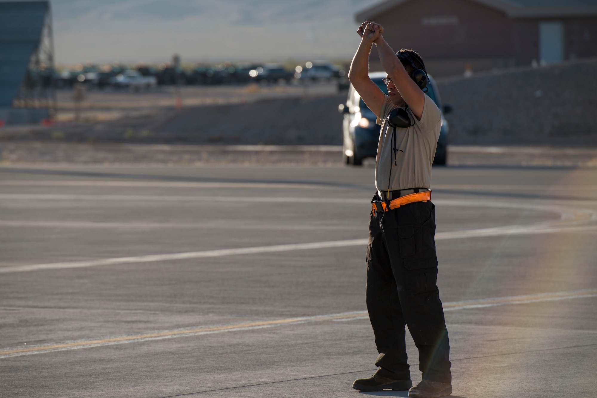 An image of Airman 1st Class Connor Badton, 3911st Fighter Squadron assistant dedicated crew chief, taxies an F-15E Strike Eagle during Green Flag West, June 13, 2018, at Nellis Air Force Base, Nevada. The 391st FS participated in Green Flag to further enhance readiness by training on Close Air Support over the National Training Center, Fort Irwin, California. (U.S. Air Force Photo by Airman 1st Class JaNae Capuno)