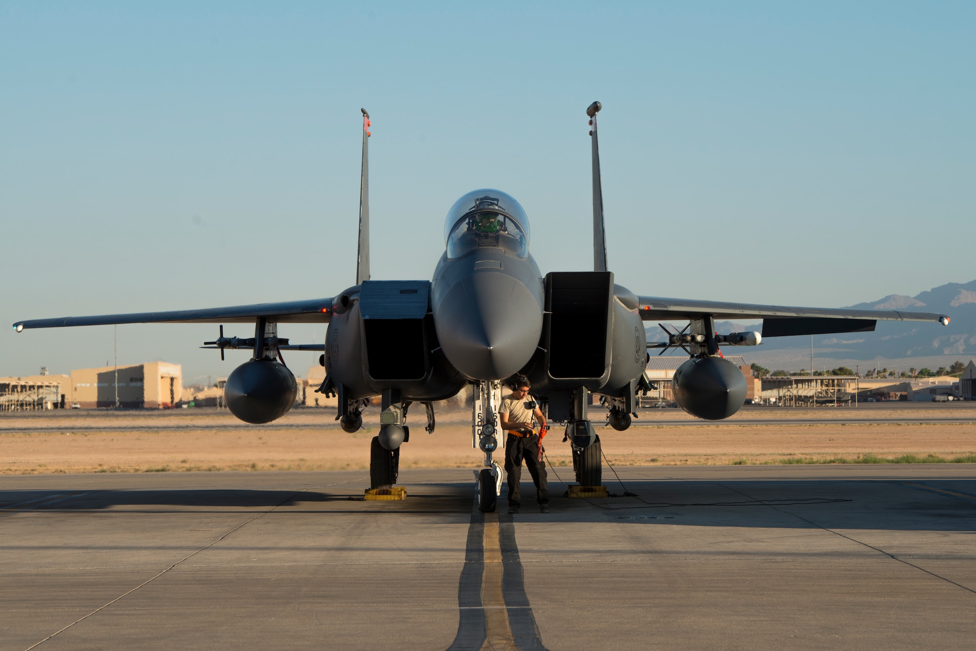 Image of Airman 1st Class Connor Badton, 3911st Fighter Squadron assistant dedicated crew chief, performs a pre-flight inspection during Green Flag West, June 13, 2018, at Nellis Air Force Base, Nevada. The 391st FS participated in Green Flag to further enhance readiness by training on Close Air Support over the National Training Center, Fort Irwin, California. (U.S. Air Force Photo by Airman 1st Class JaNae Capuno)