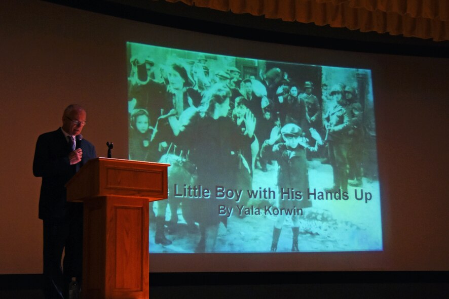 17th Training Wing historian, John Garrett, reads the poem “Little Boy with His Hands Up,” written by Yala Korwin during the Holocaust Remembrance at the Event Center on Goodfellow Air Force Base, Texas, June 14, 2018. The remembrance was a chance for Goodfellow members to learn more about the holocaust from a Warshaw Ghetto survivor. (U.S. Air Force Photo by Airman 1st Class Zachary Chapman/Released)