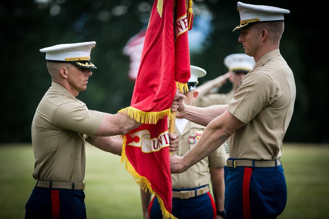 U.S. Marine Corps Maj. Brooks W. Boehlert (right) relinquishes command of Marine Corps Recruiting Station Portland to Maj. Mark M. Goebel during a change of command ceremony aboard Fort Vancouver, Wa., June 15, 2018. The change of command ceremony represents the changing of authority between outgoing Maj. Boehlert and the incoming Maj. Goebel. (U.S. Marine Corps imagery by Sgt. Travis Gershaneck/Released)