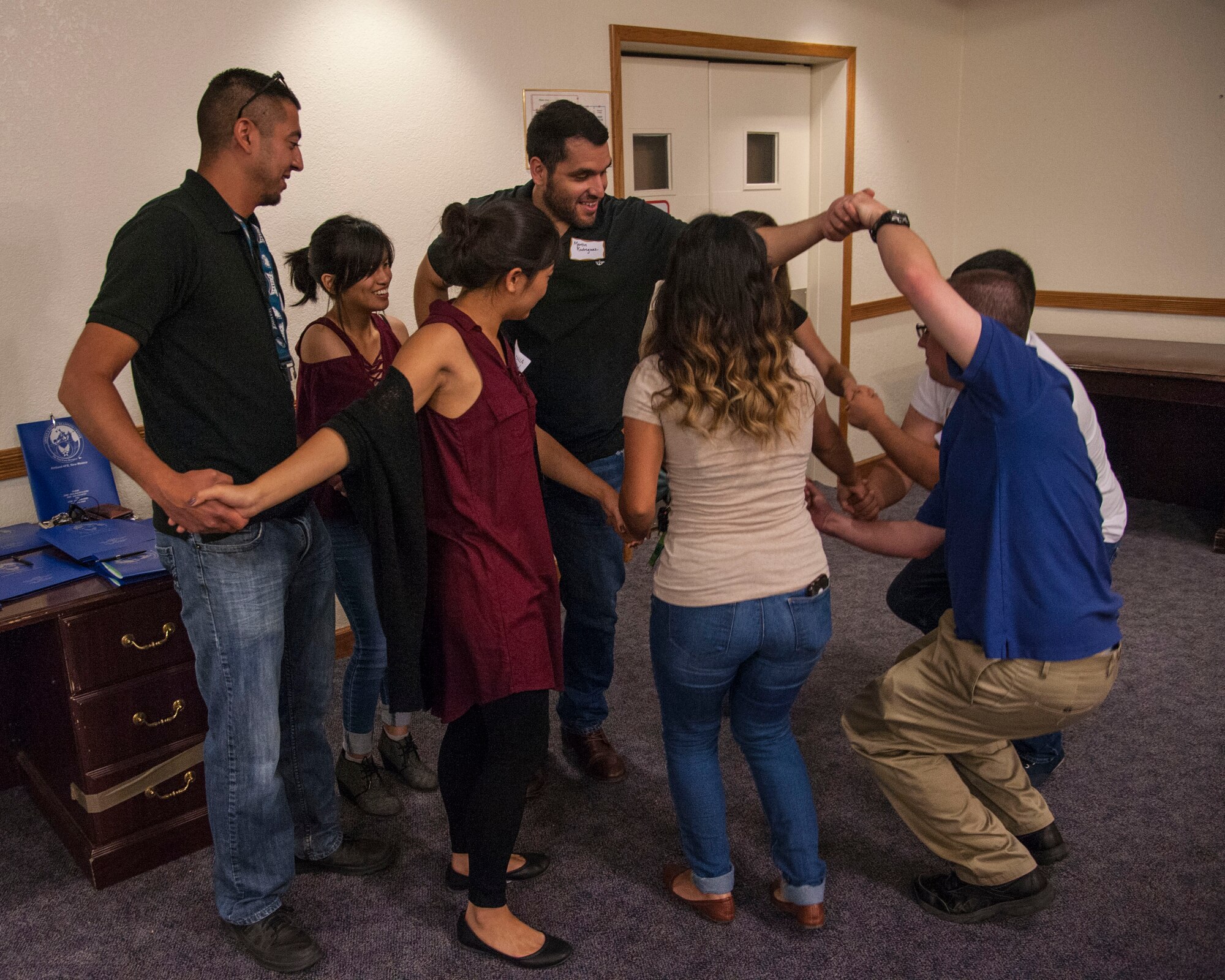 Interns at Team Kirtland units, including the Air Force Nuclear Weapons Center, Air Force Operational Test and Evaluation Center, and the 377 Air Base Wing do a team-building exercise dubbed "the human knot" June 15 here. (Air Force photo by Jim Fisher)