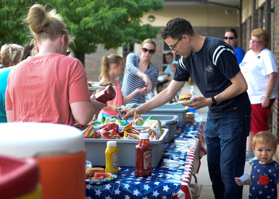 Families line up to get food at the Ellsworth Air Force Base Child Development Center’s Eighth Annual Flag Day Picnic.  Ellsworth Child Development Center celebrated the national observance during their Eighth Annual Flag Day Picnic. (U.S. Air Force photo by Senior Airman Michella Stowers)