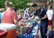 Families line up to get food at the Ellsworth Air Force Base Child Development Center’s Eighth Annual Flag Day Picnic.  Ellsworth Child Development Center celebrated the national observance during their Eighth Annual Flag Day Picnic. (U.S. Air Force photo by Senior Airman Michella Stowers)