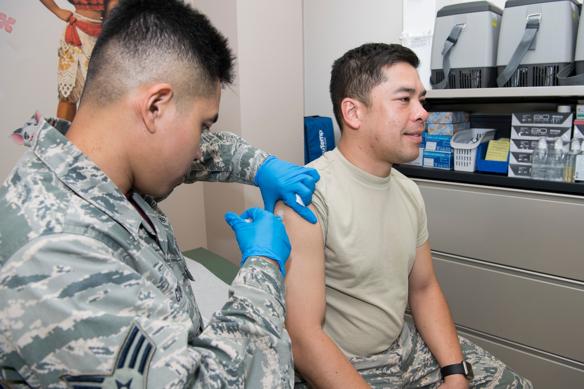 U.S. Air Force Senior Airman John Cortez, Air Force Reserve’s 624th Aerospace Medicine Flight immunizations backup technician, administers a vaccination to Airman 1st Class Ryan Martinez, Air National Guard’s 254th Air Base Group client systems specialist, as part of individual medical readiness requirements during a unit training assembly at Andersen Air Force Base, Guam, June 3, 2018.