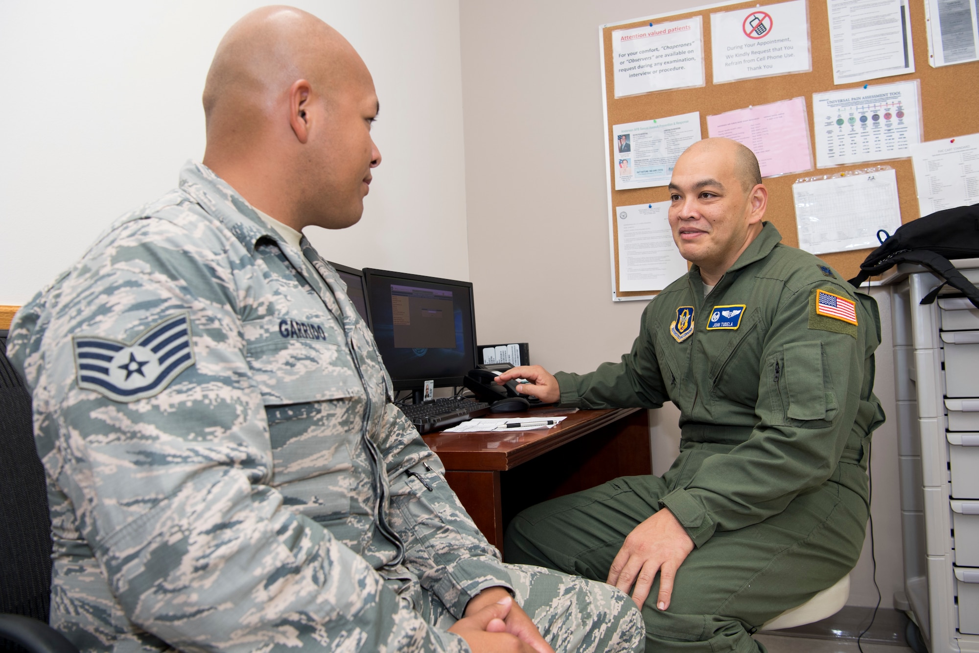 U.S. Air Force Lt. Col. John Tudela, Air Force Reserve’s 624th Aerospace Medicine Flight commander and flight surgeon, talks with Staff Sgt. Roby Garrido, Air National Guard’s 254th Red Horse Squadron management and analysis journeyman, as part of individual medical readiness requirements during a unit training assembly at Andersen Air Force Base, Guam, June 3, 2018.
