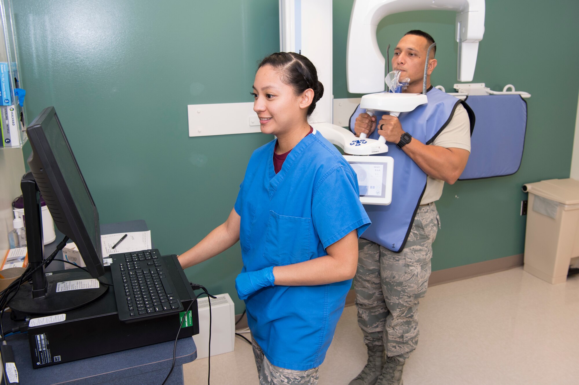 U.S. Air Force Airman 1st Class Stephanie Tenorio, Air Force Reserve’s 624th Aerospace Medicine Flight dental assistant, prepares to take a dental x-ray for Staff Sgt. Jesse San Nicolas, Air National Guard’s 254th Red Horse Squadron pavement and equipment craftsman, as part of individual medical readiness requirements during a unit training assembly at Andersen Air Force Base, Guam, June 3, 2018.