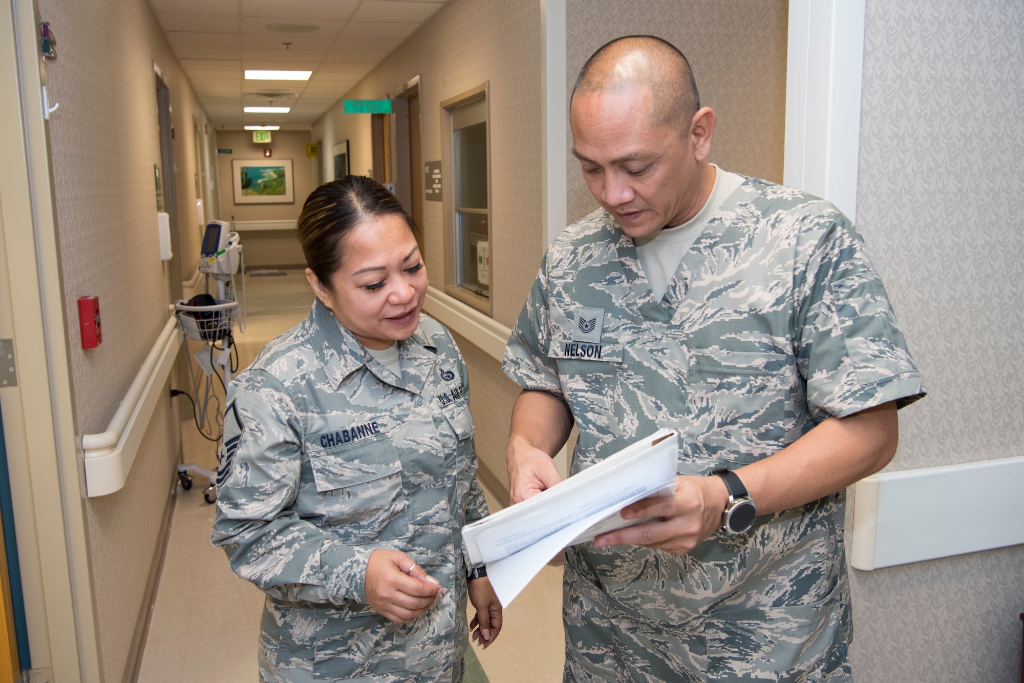 U.S. Air Force Tech. Sgt. Vincent Nelson, 624th Aerospace Medicine Flight dental services non-commissioned officer in charge, discusses medical documents with Master Sgt. Jean Chabanne, Air National Guard’s 254th Air Base Group personalist, as part of individual medical readiness requirements during a unit training assembly at Andersen Air Force Base, Guam, June 3, 2018.