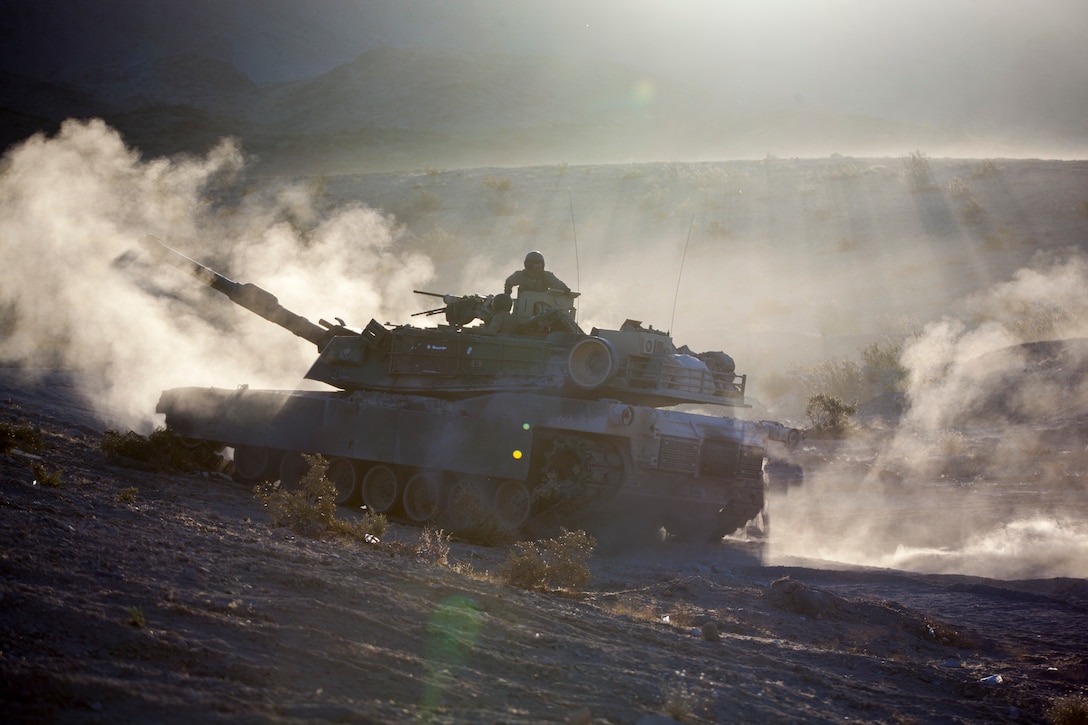 Marines with Echo Company, 4th Tank Battalion, 4th Marine Division, stage their M1A1 Abrams main battle tank for an obstacle clearing detachment practical application during Integrated Training Exercise 4-18, aboard Marine Corps Air Ground Combat Center Twentynine Palms, California, June 12, 2018. The OCD training was conducted to prepare Marines for the execution of a live-fire combined arms breach in which mechanized units will detonate a 1,000 pound mine clearing charge.