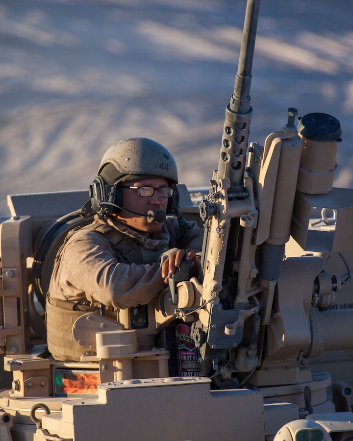A Marine with 1st Platoon, Alpha Company, 4th Combat Engineer Battalion, 4th Marine Division, sits in the turret of an Assault Breacher Vehicle before an obstacle clearing detachment practical application, during Integrated Training Exercise 4-18, aboard Marine Corps Air Ground Combat Center Twentynine Palms, California, June 12, 2018. The OCD training was conducted to prepare Marines for the execution of a live-fire combined arms breach in which mechanized units will detonate a 1,000 pound mine clearing charge.