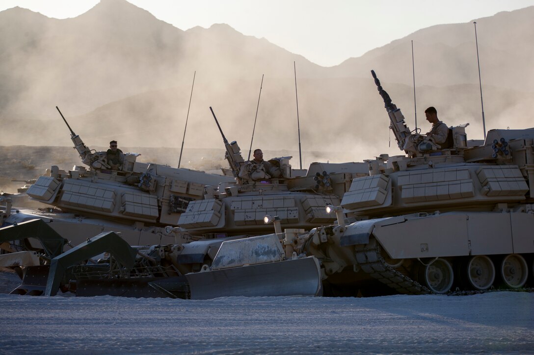 Marines with Alpha Company, 4th Combat Engineer Battalion, 4th Marine Division, dismount their Assault Breacher Vehicles to attend a safety brief prior to an obstacle clearing detachment practical application, during Integrated Training Exercise 4-18, aboard Marine Corps Air Ground Combat Center Twentynine Palms, California, June 12, 2018. The OCD training was conducted to prepare Marines for the execution of a live-fire combined arms breach in which mechanized units will detonate a 1,000 pound mine clearing charge.