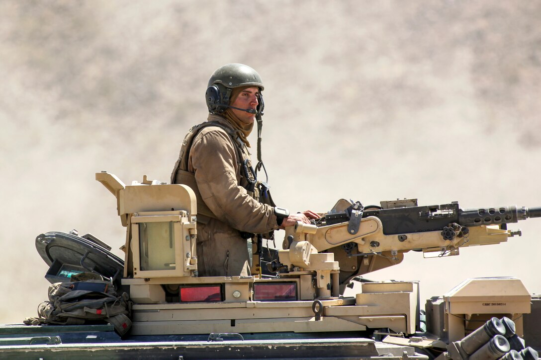 A Marine with Alpha Company, 4th Combat Engineer Battalion, 4th Marine Division, observes fellow Marines after completing the second evolution of an obstacle clearing detachment practical application, during Integrated Training Exercise 4-18, aboard Marine Corps Air Ground Combat Center Twentynine Palms, California, June 12, 2018. The OCD training was conducted to prepare Marines for the execution of a live-fire combined arms breach in which mechanized units will detonate a 1,000 pound mine clearing charge.