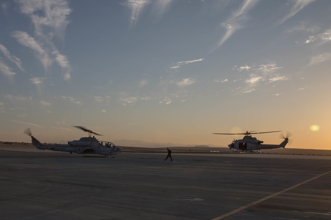 Marines with Marine Light Attack Helicopter Squadron 775, Marine Aircraft Group-41, 4th Marine Aircraft Wing, take off in a AH-1W SuperCobra attack helicopter(left) and a UH-1Y Venom(right) for night operations during Integrated Training Exercise 4-18 in Marine Corps Air Ground Combat Center Twentynine Palms, California, June 12, 2018. HMLA-775, also known as the “Coyotes”, provides air combat element support to Marine Air Ground Task Force 23 during ITX 4-18.  (U.S. Marine Corps photo by Lance Cpl. Samantha Schwoch/released)