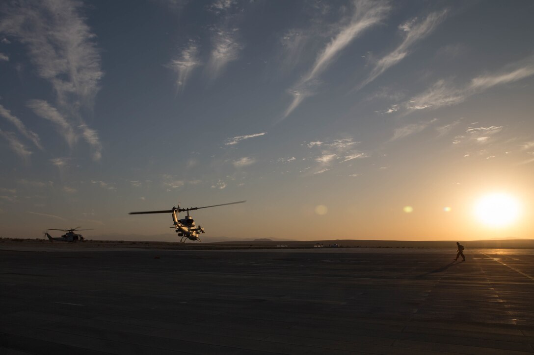 Marines with Marine Light Attack Helicopter Squadron 775, Marine Aircraft Group-41, 4th Marine Aircraft Wing, take off in a UH-1Y Venom(left) and a AH-1W SuperCobra attack helicopter(right) for night operations during Integrated Training Exercise 4-18 in Marine Corps Air Ground Combat Center Twentynine Palms, California, June 12, 2018. HMLA-775, also known as the “Coyotes”, provides air combat element support to Marine Air Ground Task Force 23 during ITX 4-18.  (U.S. Marine Corps photo by Lance Cpl. Samantha Schwoch/released)