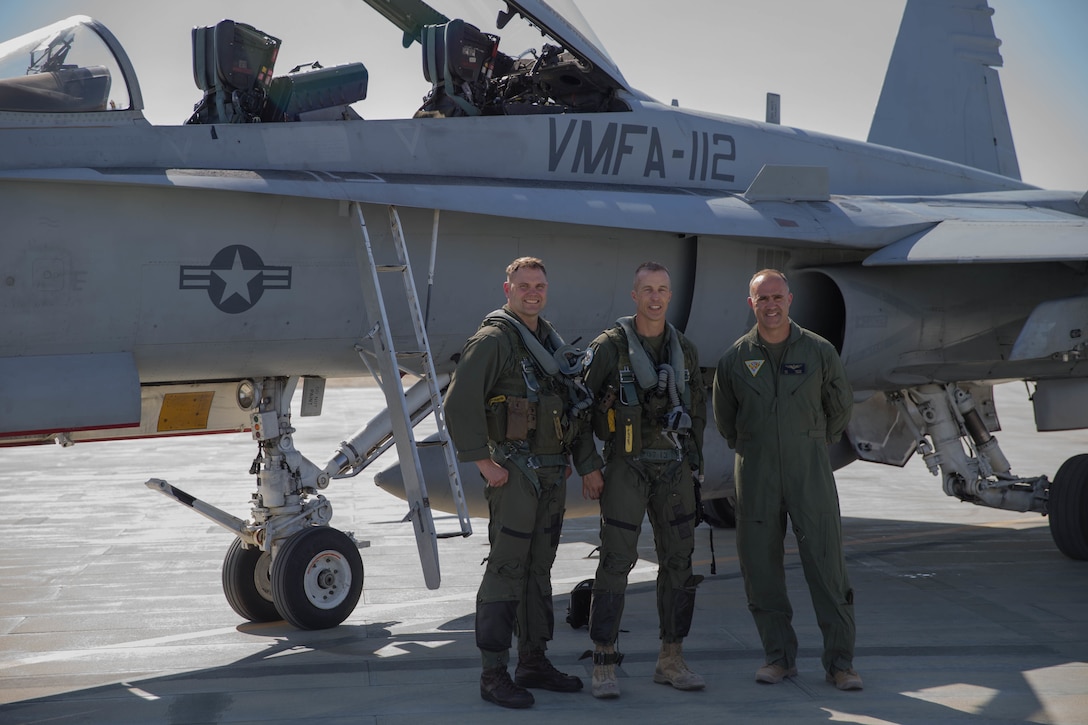 Lt. Col. Jeremy Yauck (left), F/A-18 Hornet pilot with Marine Fighter Attack Squadron 112, Marine Aircraft Group 41, 4th Marine Aircraft Wing, Col. Steven J. White (center), commanding officer of Marine Air Ground Task Force 23, and Col. Matthew F. Amidon, commanding officer of MAG-41, 4th MAW, pose for a photograph in front of the F/A-18 Hornet during Integrated Training Exercise 4-18 at Marine Corps Air Ground Combat Center Twentynine Palms, California, June 10, 2018. ITX 4-18 provides MAGTF elements an opportunity to undergo a service-level assessment of core competencies that are essential to expeditionary, forward-deployed operations. (U.S. Marine Corps photo by Lance Cpl. Samantha Schwoch/released)