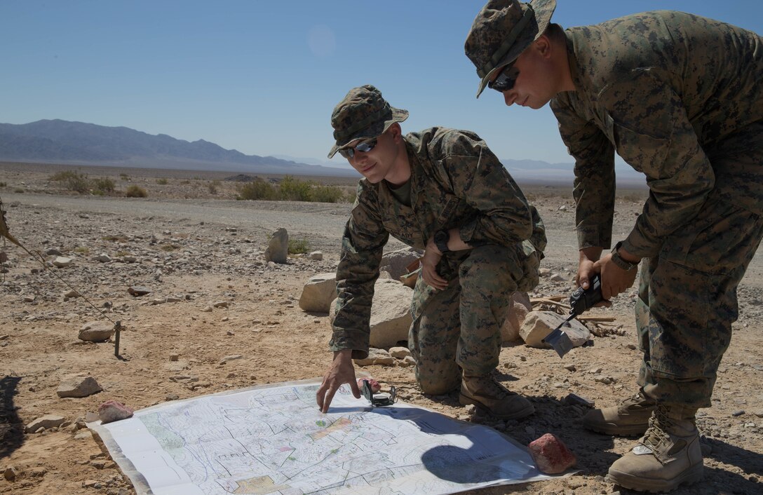 Lance Cpl. Robert Gready, an ammunition technician, and Lance Cpl. Ernest Houser, a Marine anti-tank missileman, with Weapons Company, 1st Battalion, 23rd Marine Regiment, 4th Marine Division, calculate the route distance to range 410A, a platoon reinforced attack range, during Integrated Training Exercise 4-18 at Marine Corps Air Ground Combat Center Twentynine Palms, California, June 11, 2018. ITX 4-18 provides MAGTF elements an opportunity to undergo a service-level assessment of core competencies that are essential to expeditionary, forward-deployed operations. (U.S. Marine Corps photo by Lance Cpl. Samantha Schwoch/released)