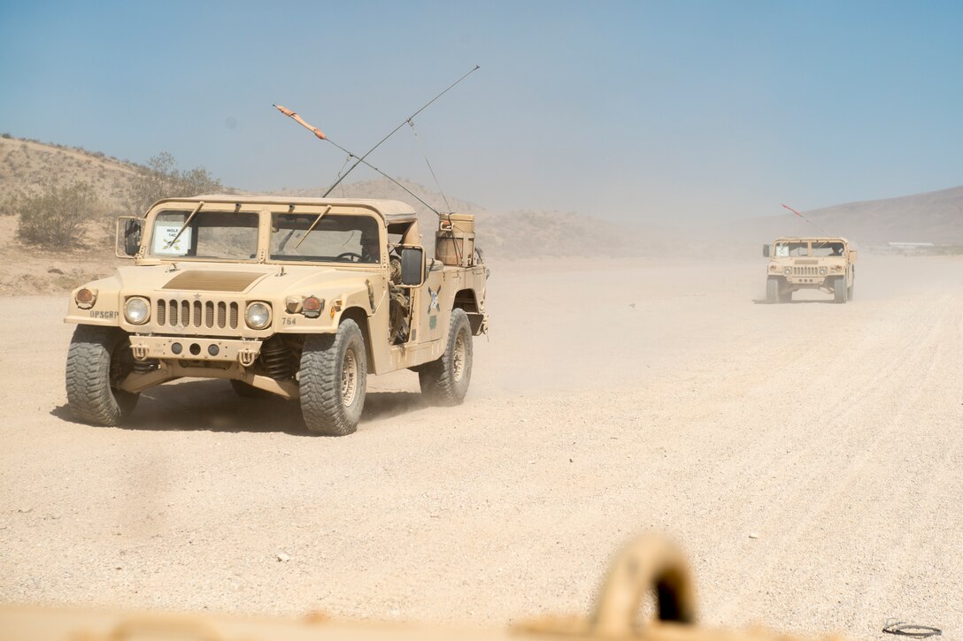 Humvees drive down a dirt path during Green Flag West, June 12, 2018, at the National Training Center, Ft. Irwin, California. The NTC replicates the tough, realistic operational environment that America’s war fighters face in combat. (U.S. Air Force photo by Airman 1st Class JaNae Capuno)