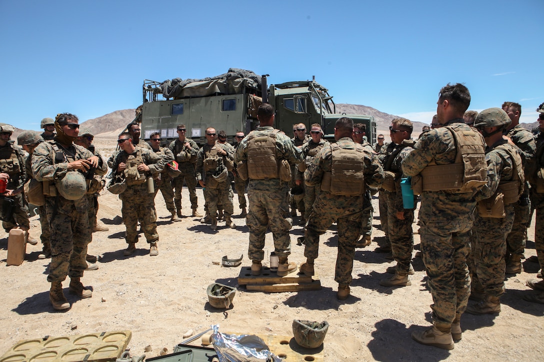 Marines with Mike Battery, 3rd Battalion, 14th Marine Regiment, 4th Marine Division, debrief after a successful direct fire shoot at Integrated Training Exercise 4-18 in Twentynine Palms, California, June 13, 2018. ITX 4-18 is a live-fire and maneuver combined arms exercise designed to train battalion and squadron-sized units in tactics, techniques, and procedures required to provide a sustainable and ready operational reserve for employment across the full spectrum of crisis and global employment.