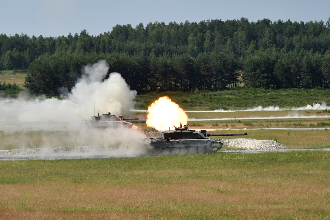 British soldiers fire their tanks main battle guns.