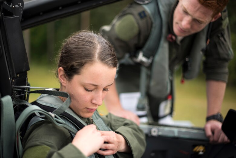 U.S. Air Force Academy cadet Christen Dahl straps into an F-15D eagle prior to her familiarization flight at Royal Air Force Lakenheath, England, June 13. Six U.S. Air Force Academy cadets were imbedded in 48th Fighter Wing operations part of a two-week summer program called “Operation Air Force.”  (U.S. Air Force photo/ Senior Airman Malcolm Mayfield)