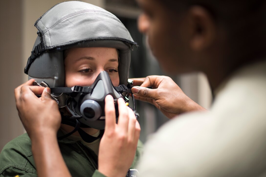 U.S. Air Force Academy cadet Christen Dahl is fitted for a helmet by an Aircrew Flight Equipment Technician assigned to 493rd Fighter Squadron at Royal Air Force Lakenheath, England, June 13. Six U.S. Air Force Academy cadets were imbedded in 48th Fighter Wing operations part of a two-week summer program called “Operation Air Force.” (U.S. Air Force photo/ Senior Airman Malcolm Mayfield)