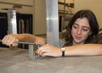 Cassie Dennison, a Florida State University freshman, tightens a bolt on an unmanned system June 12, 2018 at Naval Surface Warfare Center Panama City Division. Dennison is a Naval Research Enterprise Internship Program intern who will work at NSWC PCD for 10 weeks. Twenty-six interns were selected in 2018 for the competitive 10-week paid internship offered to students across the United States. (RELEASED) U.S. Navy photo by Ronnie Newsome.