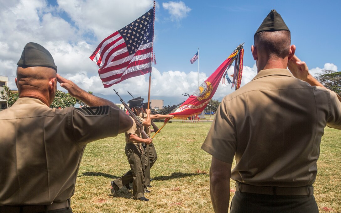 U.S. Marine Corps Col. Michael Styskal, commanding officer of 3rd Marine Regiment, and Master Gunnery Sgt. Dean Weichert, the 3rd Marine Regiment motor transportation chief, salute the national flag and regimental battle colors during a retirement ceremony for Weichert, Marine Corps Base Hawaii, June 15, 2018. Weichert retired from the U.S. Marine Corps after 30 years of honorable and faithful service.