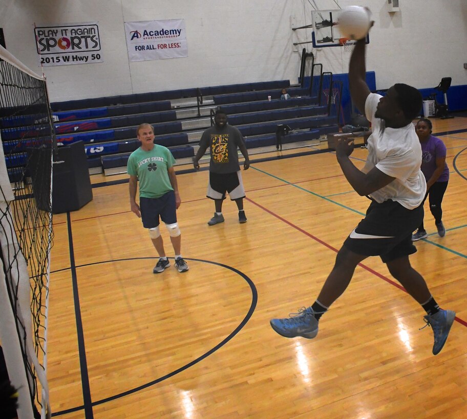 At far right in purple, Master Sgt. Dawn Williams, 932nd Health Professions Recruiter, encourages her team to return the volleyball over the net at Scott Air Force Base, Ill.  She recruits new medical people into the Air Force Reserve by day, and also coaches the 932nd Airlift Wing's volunteer volleyball team.  The next volunteer sport competition this summer is softball.  (U.S. Air Force photo by Lt. Col. Stan Paregien)