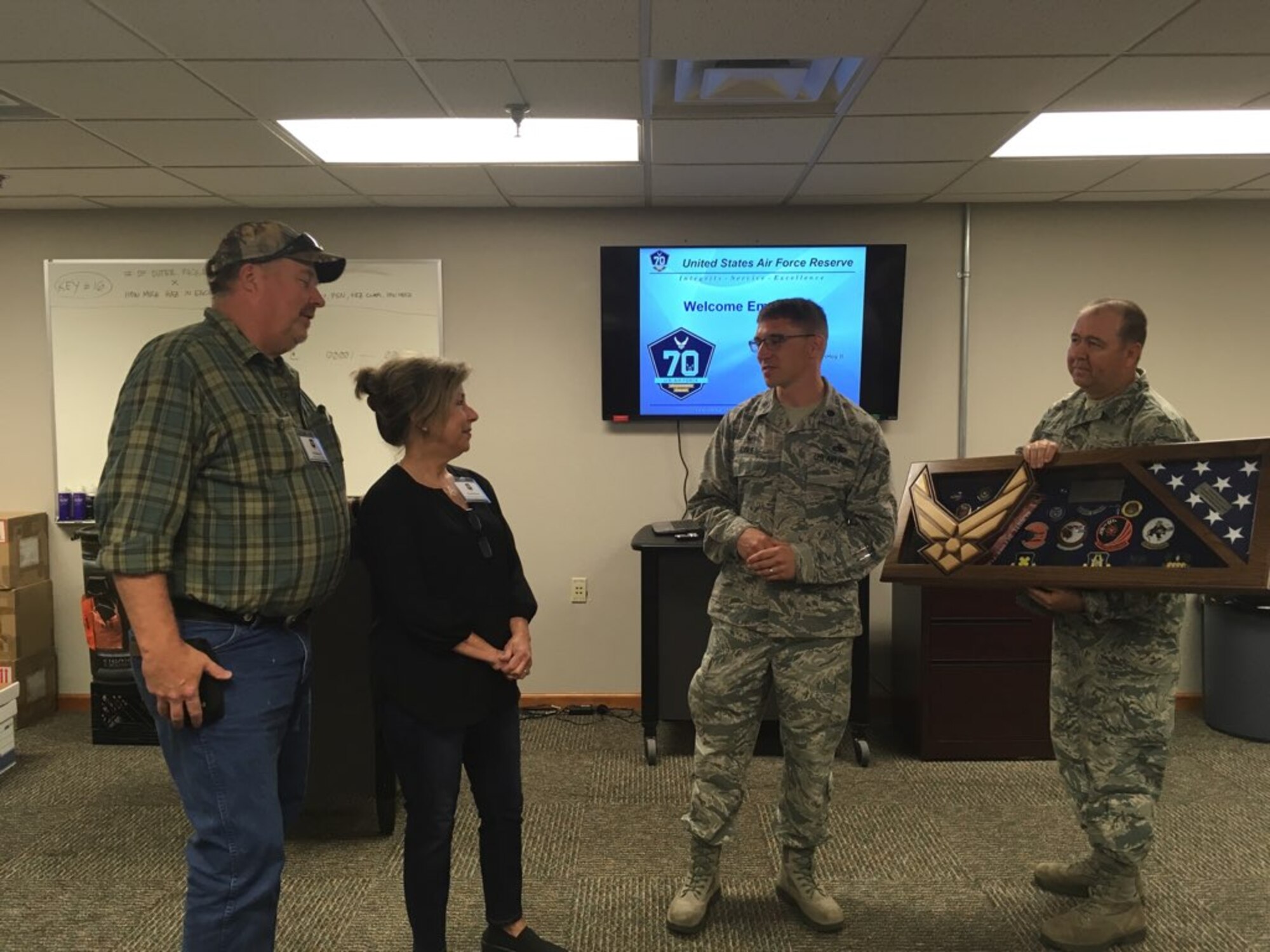 Hal Moore and his wife, Christy, accept a shadow box from U.S. Air Force Lt. Col. George Cole, 307th Maintenance Squadron commander and Master Sgt. Gene Watkins, 307th MXS metals technology supervisor, during Employer Appreciation Day at Barksdale Air Force Base, June 2, 2018.   The 307th MXS expressed their appreciation to Moore, owner of Moore Metal Plating Corporation, for his unwavering commitment to the Air Force mission for the past several decades. (U.S. Air Force photo by Staff Sgt. Callie Ware/released)