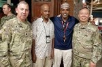 Lt. Col. (Chaplain) Bill Draper and Col. (Chaplain) Yong Cho visit with two KBR employees attending the Iftar on Camp Lemonnier in Djibouti, Africa May 21, 2018.