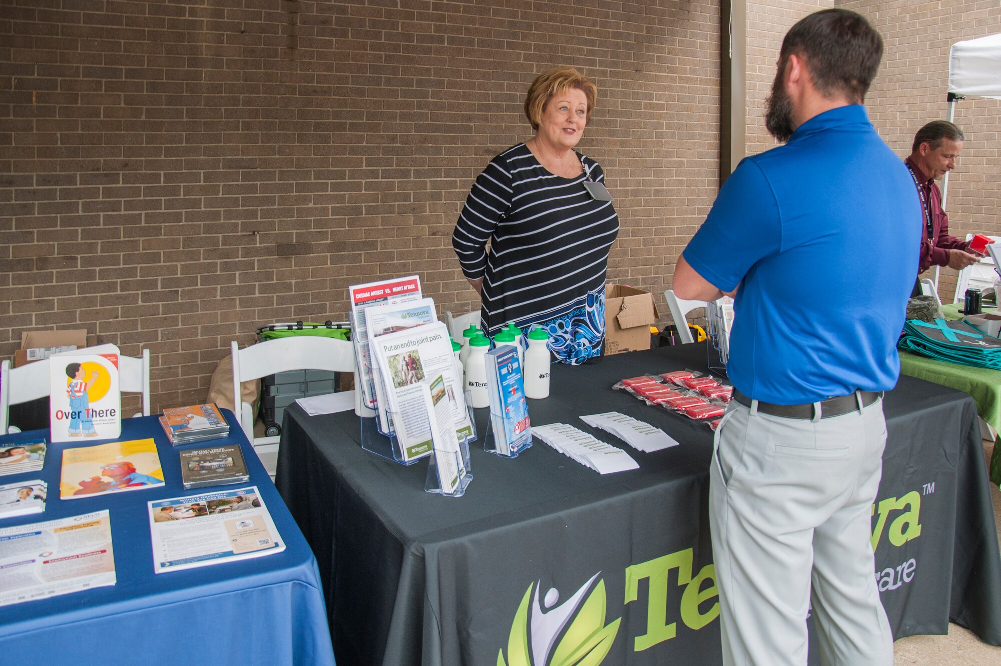 Ava Lynch, representative with Tennova Healthcare, speaks to one of the attendees about the healthcare services offered by her organization during the Arnold Air Force Base Community Health Fair on June 1 at the Base Exchange and Commissary.  (U.S. Air Force photos/Jacqueline Cowan)