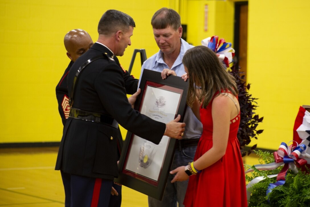 Hunter A. Northcutt’s father, Marty Northcutt, and sister, Tori Northcutt, receive the Honorary Marine award in his honor from Col. Jeffrey C. Smitherman, 6th Marine Corps District Commanding Officer, at Pelham Elementary School, Pelham, Tennessee, June 13, 2018. Hunter was distinguished Honorary Marine posthumously by Gen. Robert B. Neller, Commandant of the Marine Corps, for embodying the Marine core values of honor, courage and commitment. (U.S. Marine Corps photo by Sgt. Mandaline Castillo)
